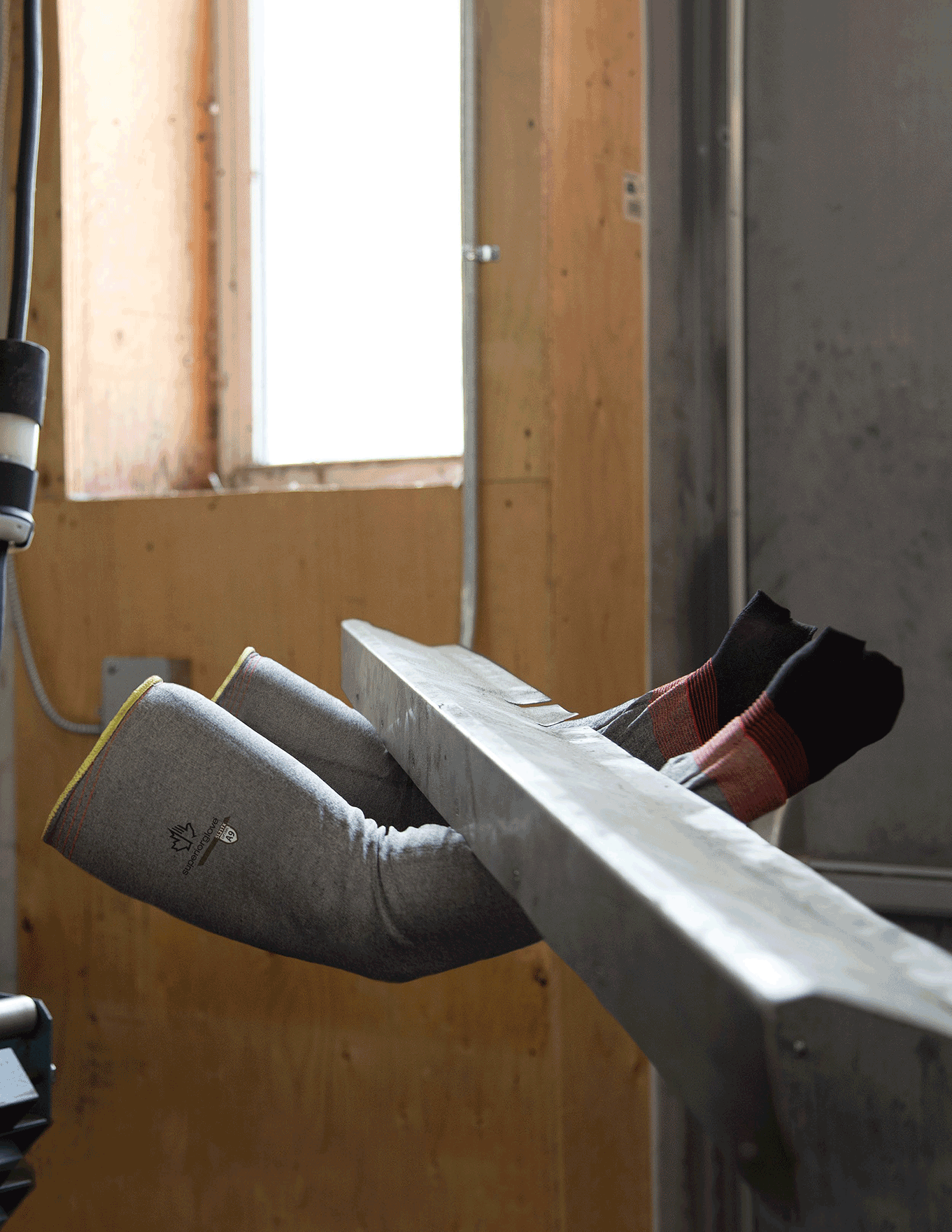 Protective cut resistant sleeve holding a piece of steel