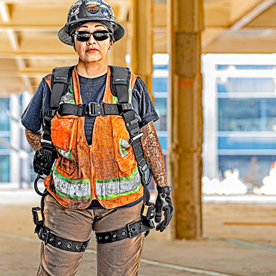 Woman standing wearing a properly fitted fall protection harness